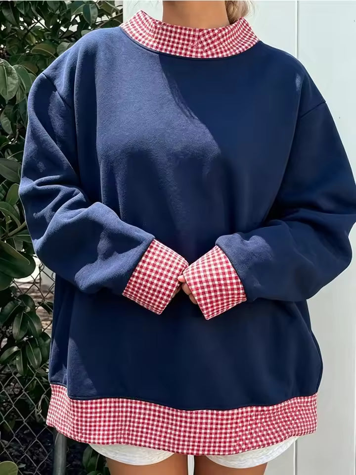 Hazel White relaxed-fit sweatshirt featuring a round neckline, contrasting polka-dot cuffs, and decorative hem trim