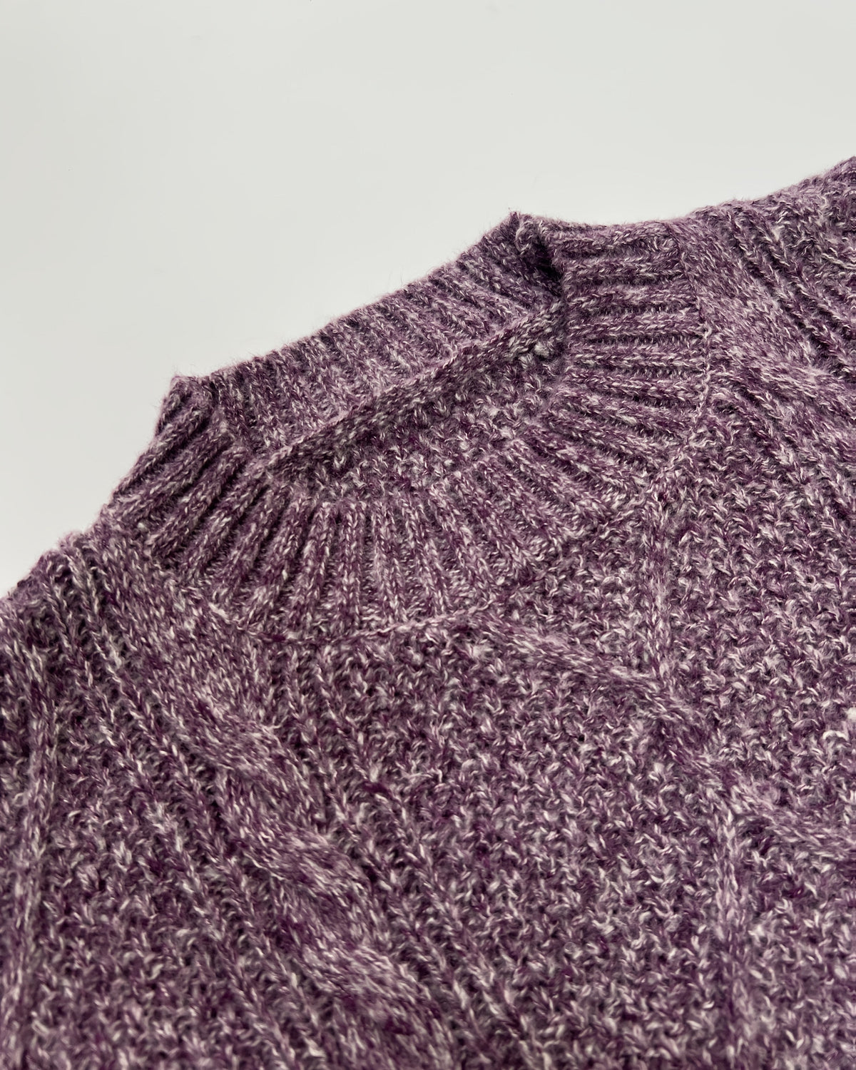 Helene Purple cable-textured sweater dress shown in close-up with detailed geometric knit texture and round neckline