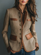 Isabella Brown herringbone jacket featuring a collarless neckline, faux-leather trim, front buttons, tailored silhouette, and decorative chest pockets