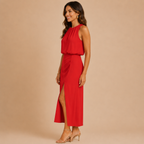 Side view of the Isla Sleeveless Halter Maxi Dress Side-Slit in red, showcasing the sleeveless halter neckline, flattering drape, and elegant side slit. Designed by Bella Hudson.