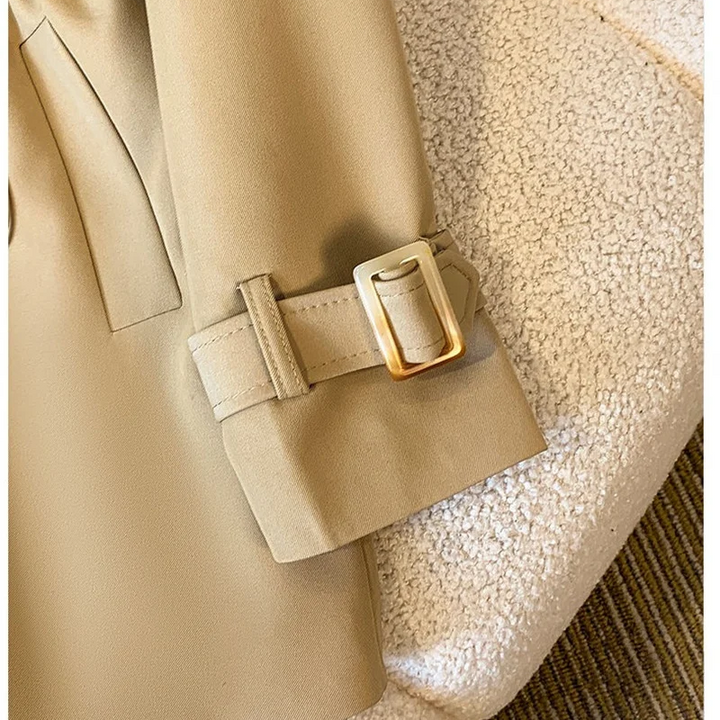 Close-up cuff detail of the Jennifer Trench Coat Belted Double-Breasted in khaki, showcasing the adjustable buckle strap and structured long sleeve. Designed by Bella Hudson.