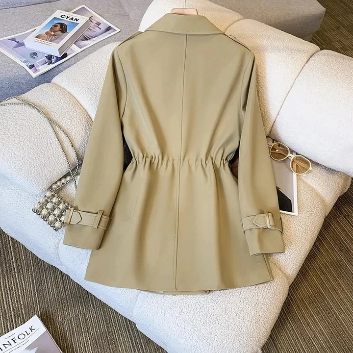 Full product view of the Jennifer Trench Coat Belted Double-Breasted in khaki, showcasing the notched lapel collar, double-breasted front, belted waist, long sleeves, and structured flared silhouette. Designed by Bella Hudson.