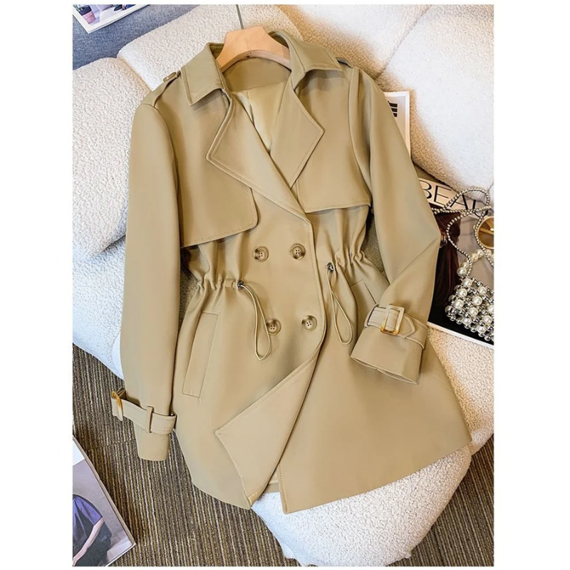 Product view of the Jennifer Trench Coat Belted Double-Breasted in khaki, featuring a notched lapel collar, double-breasted button front, long sleeves with buckle cuffs, waist belt, and flared hem. Designed by Bella Hudson.