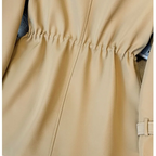 Close-up waist detail of the Jennifer Trench Coat Belted Double-Breasted in khaki, highlighting the gathered back waist and structured shaping. Designed by Bella Hudson.