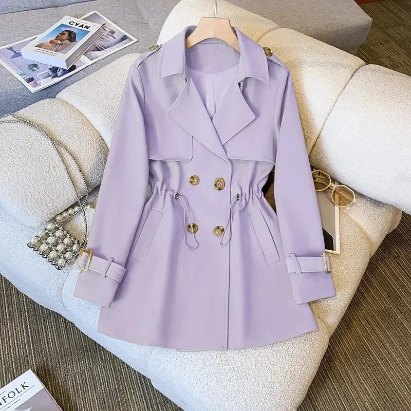 Product view of the Jennifer Trench Coat Belted Double-Breasted in purple, featuring a notched lapel collar, double-breasted button front, long sleeves with buckle cuffs, belted waist, and flared silhouette. Designed by Bella Hudson.