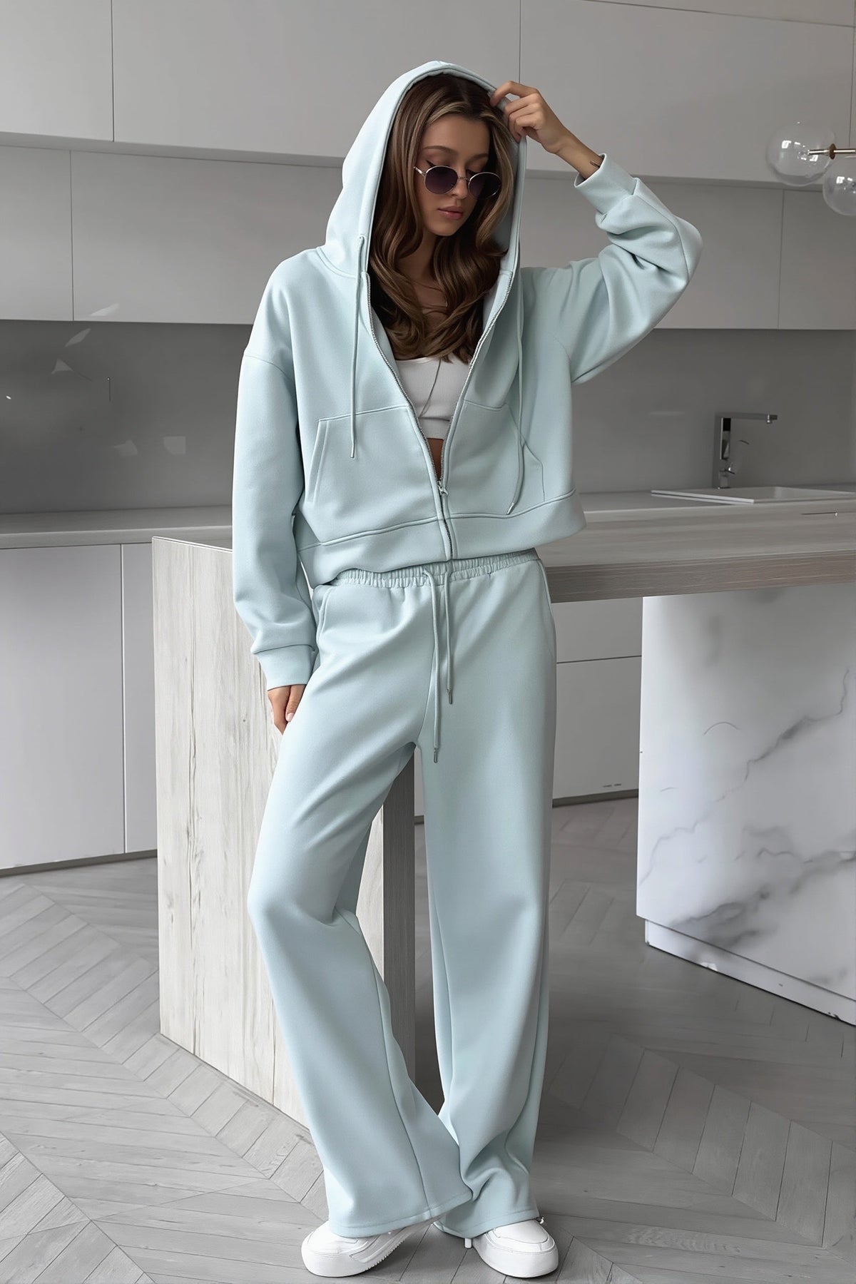 Jolene Blue zip-up hoodie with hood up and wide-leg drawstring sweatpants.