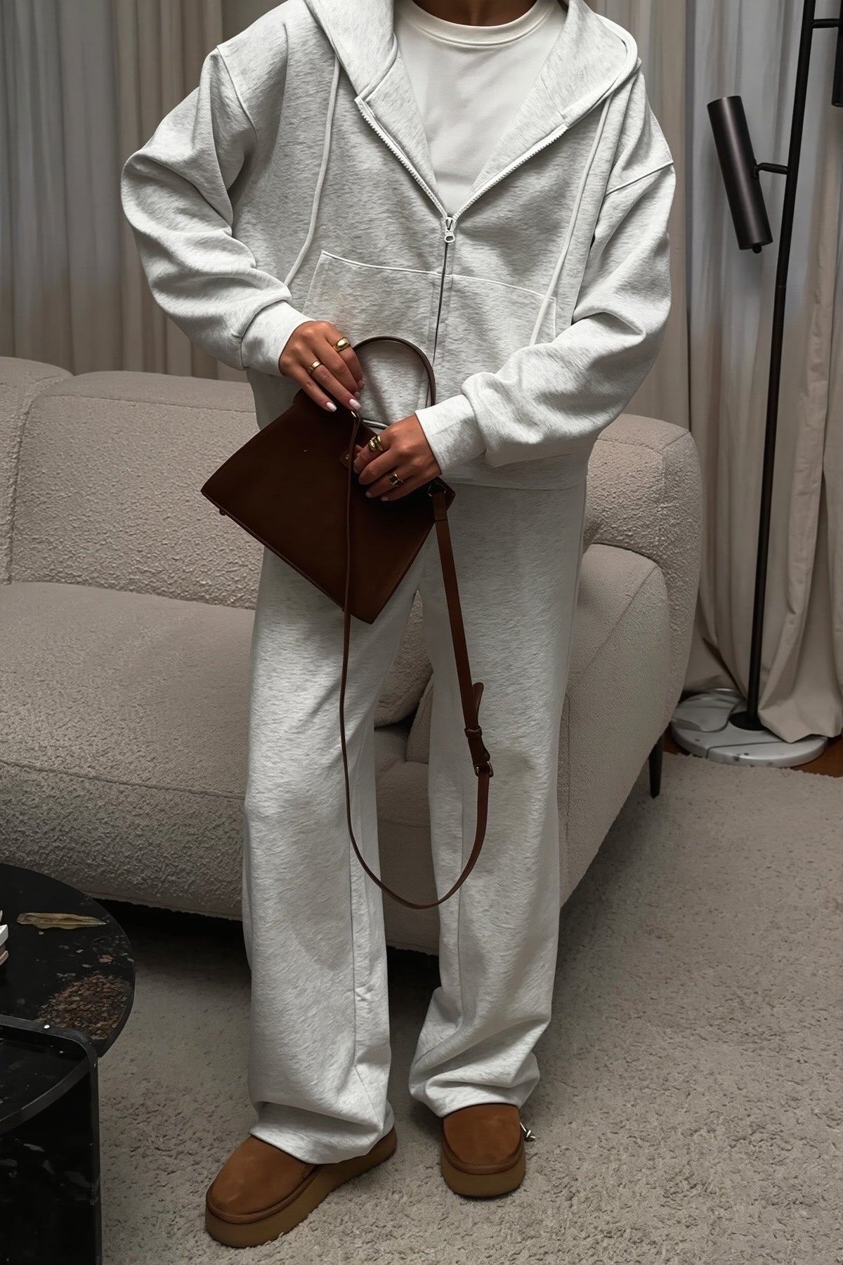 Jolene Gray heathered zip-up hoodie and wide-leg sweatpants styled with a brown bag and boots.