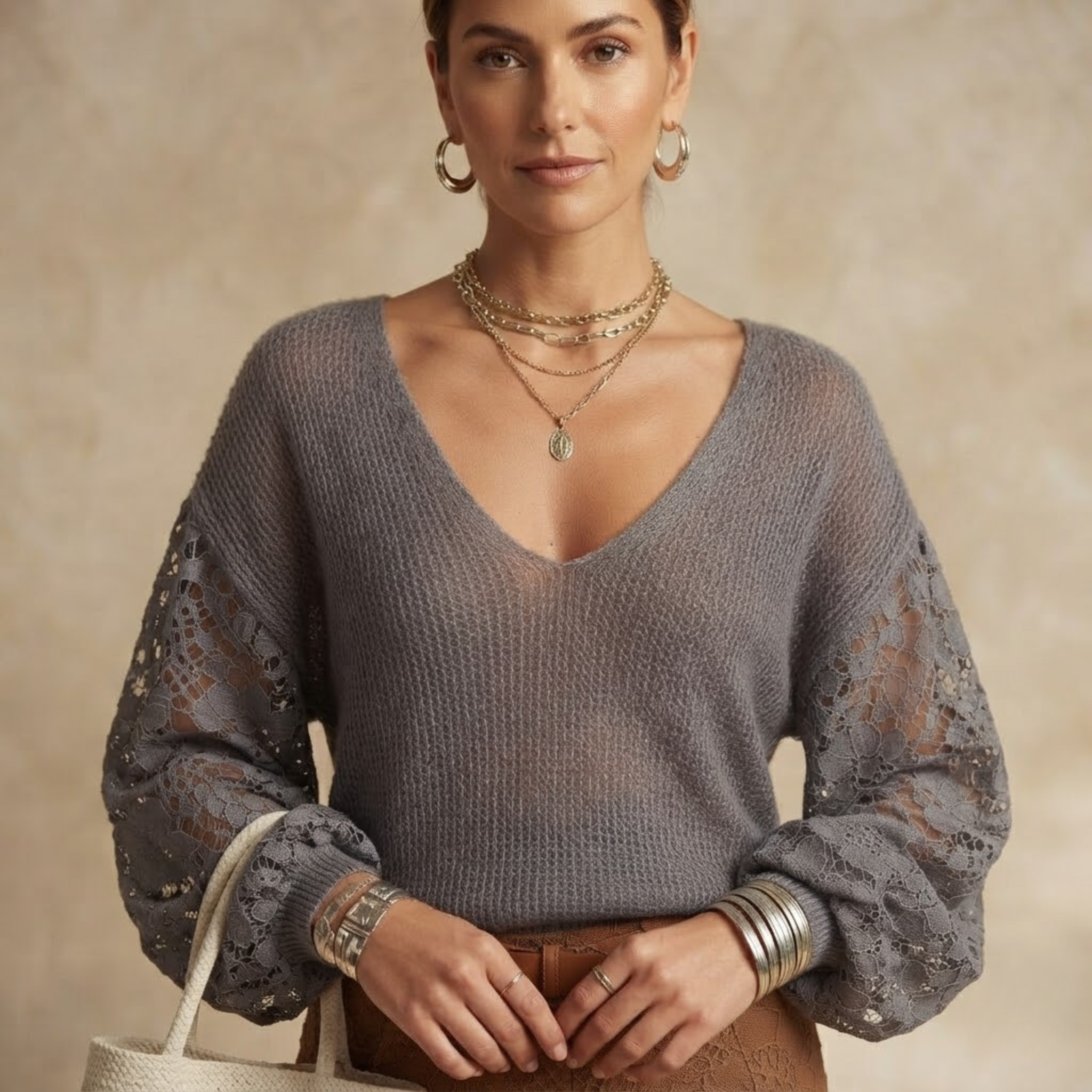 Close-up front view of the Josefine Sweater Lace V-Neck Knit in Grey, showcasing the delicate lace V-neckline and knit texture. Designed by Bella Hudson.