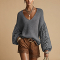 Front view of the Josefine Sweater Lace V-Neck Knit in Grey, featuring a lace V-neckline, soft knit fabric, and long sleeves. Designed by Bella Hudson.