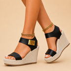Karin Supportive Platform Wedge Sandals with Ankle Strap in Black featuring a cushioned platform wedge sole, supportive ankle strap, open-toe design, and gold-tone accent detail shown in side view, designed by Bella Hudson.