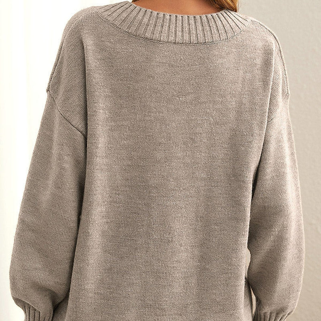 Back view of the Katharina Sweater Knit V-Neck Oversized in beige, highlighting the round back neckline, long sleeves, ribbed trim, and relaxed oversized knit silhouette. Designed by Bella Hudson.