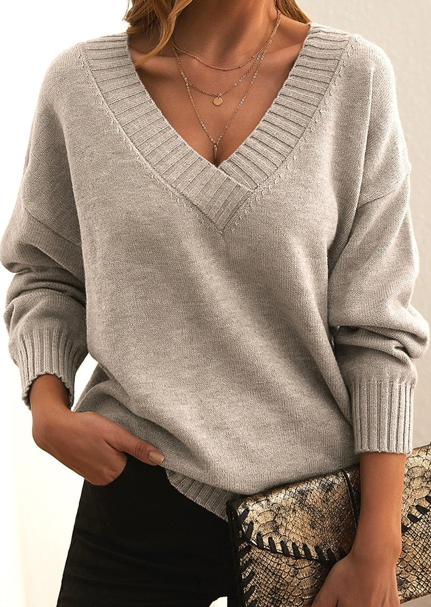 Front view of the Katharina Sweater Knit V-Neck Oversized in beige, featuring a deep V-neckline, long sleeves, ribbed cuffs, soft knit fabric, and a relaxed oversized fit. Designed by Bella Hudson.