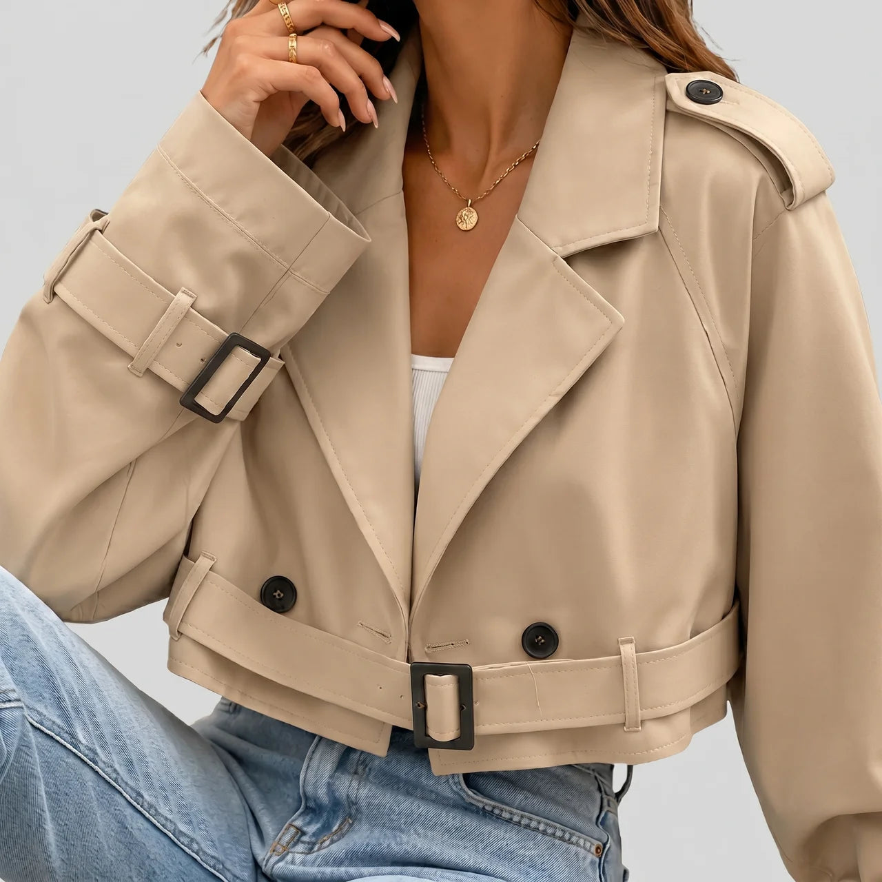 Close-up view of khaki cropped trench jacket with buckle belt and long sleeves by BELLA HUDSON