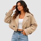 Model wearing khaki cropped trench jacket with buckle belt and long sleeves by BELLA HUDSON