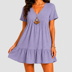 Front view of lavender tiered mini dress with short sleeves by BELLA HUDSON