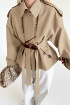 Lena Brown faux suede belted short jacket with a lapel collar, shoulder tabs, long sleeves, and defined tie waist