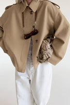 Lena Brown faux suede belted jacket in a relaxed front view with long sleeves, lapel collar, and waist tie
