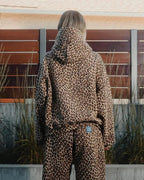 Lena Leopard hoodie set shown from the back with the hood and matching straight-leg pants.