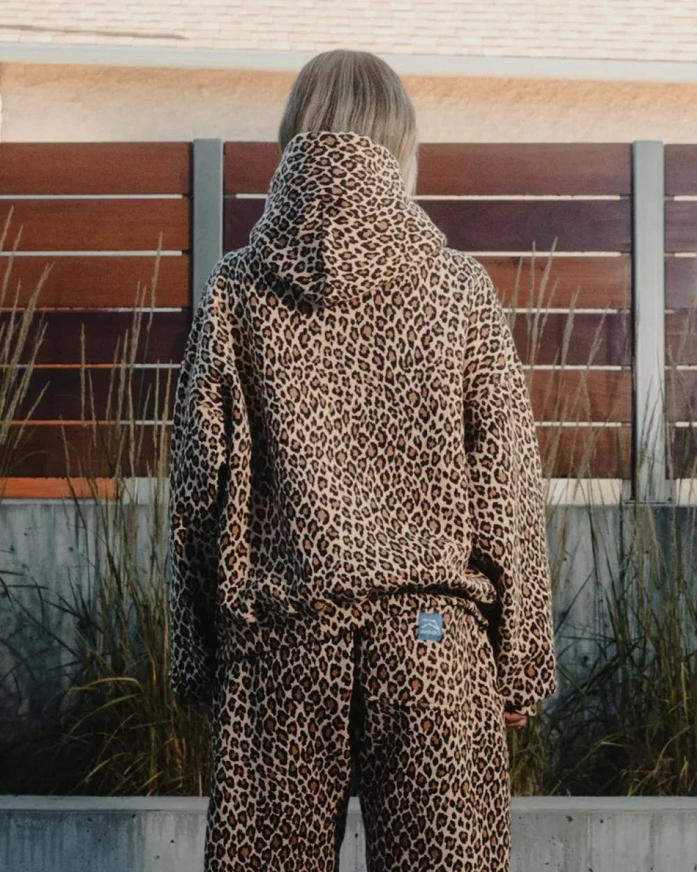 Lena Leopard hoodie set shown from the back with the hood and matching straight-leg pants.