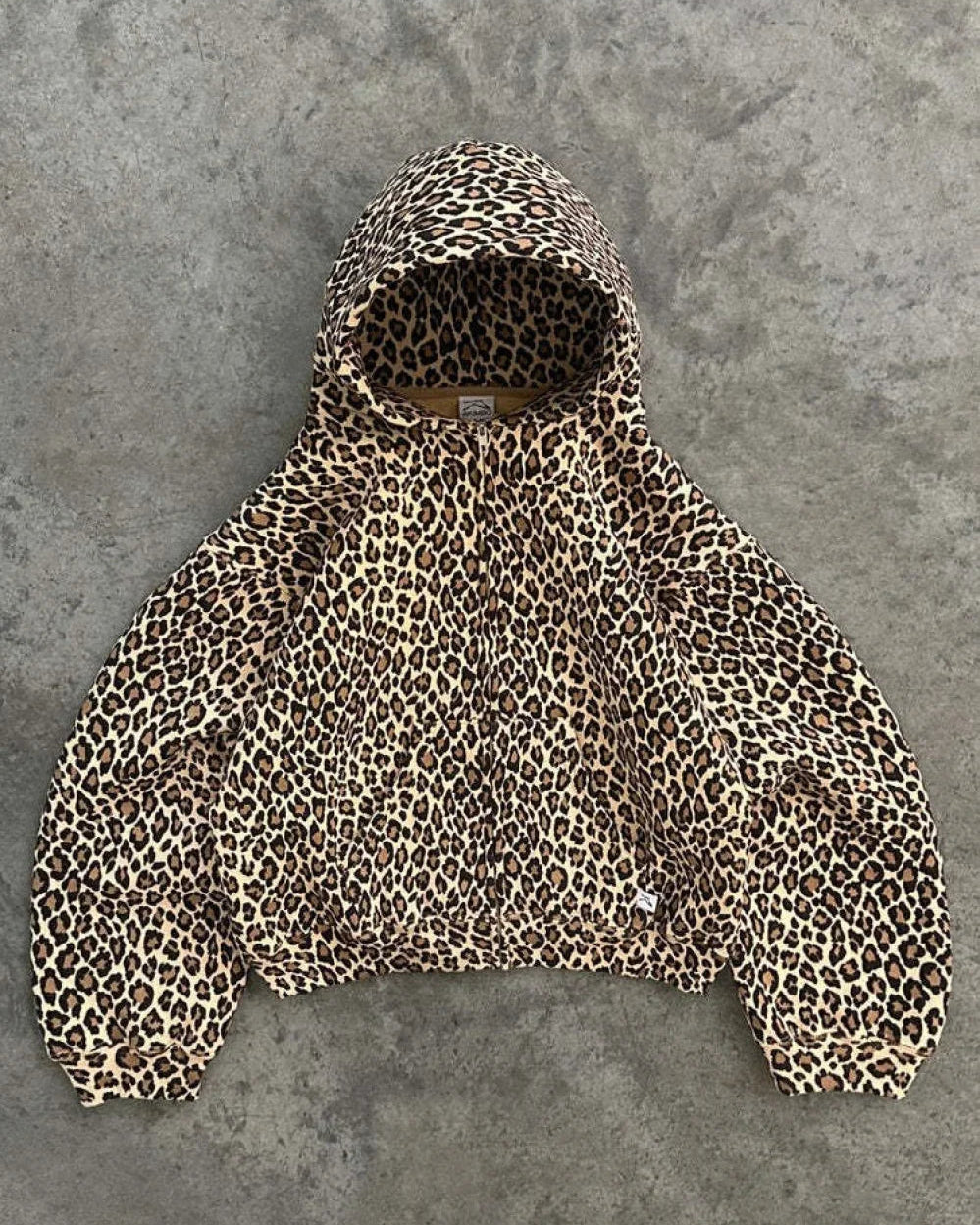 Lena Leopard hoodie laid flat showing the hood, dropped shoulders and allover leopard print.