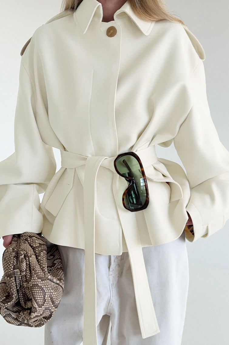 Lena White faux suede belted short jacket with a lapel collar, shoulder tabs, tie waist, and relaxed fit