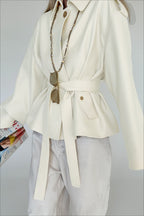 Lena White faux suede belted jacket shown from the side with a relaxed silhouette and adjustable waist tie