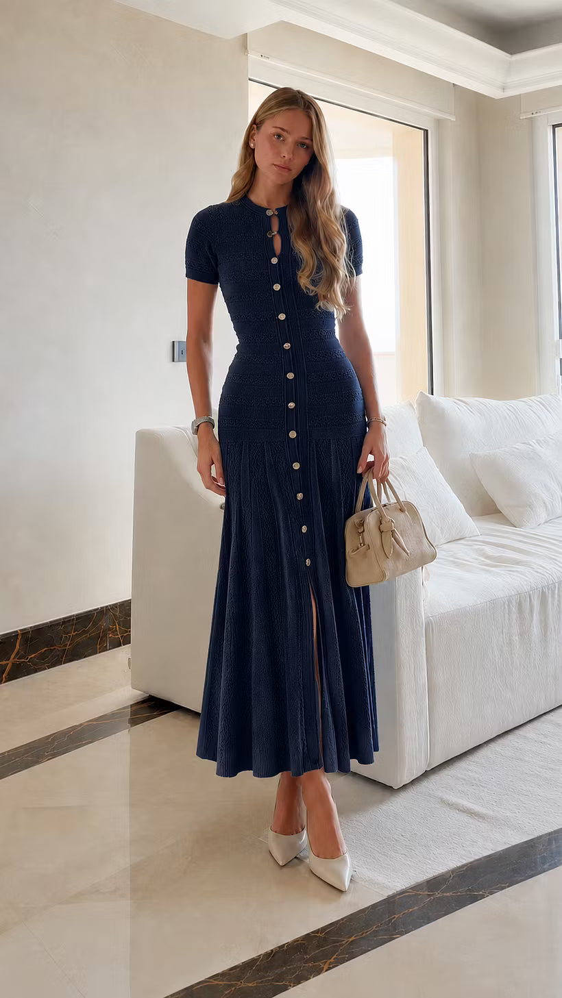 Leonie Dark Blue button-front knit maxi dress styled full-body with a beige handbag.