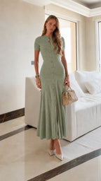 Leonie Green button-front knit maxi dress styled full-body with a beige handbag.