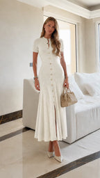 Leonie White button-front knit maxi dress styled full-body with a beige handbag.