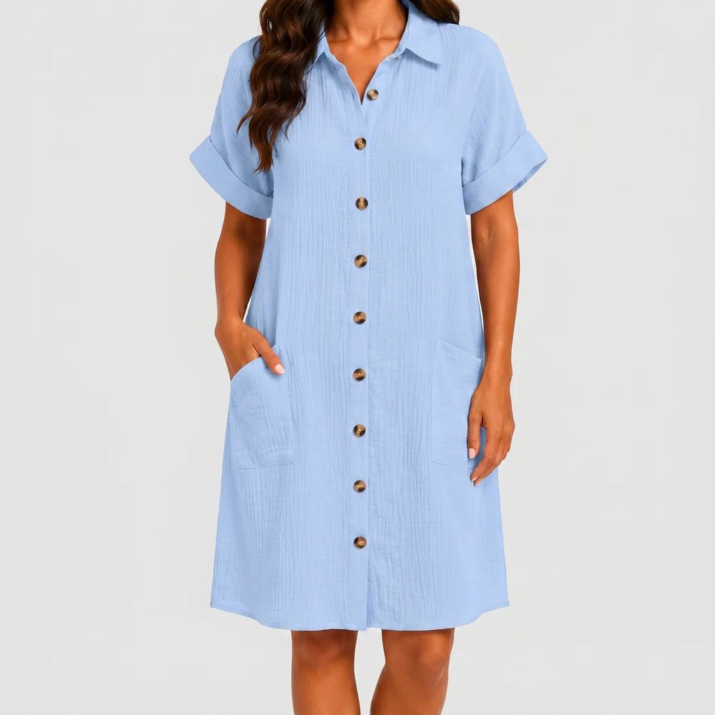 Front view of light blue button front midi dress with short sleeves and side pockets by BELLA HUDSON