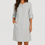 Front view of light gray linen midi dress with rolled sleeves and side pockets by BELLA HUDSON
