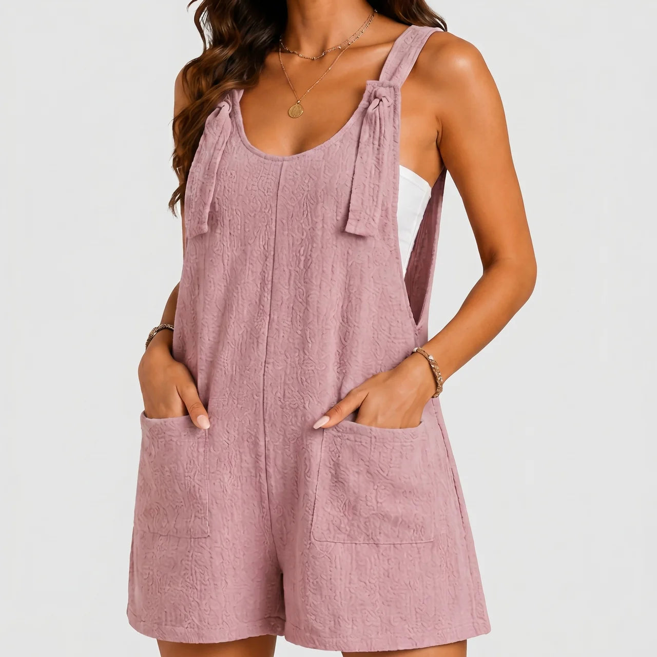 Front view of light pink sleeveless short jumpsuit with relaxed fit by BELLA HUDSON