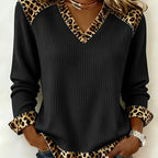 Lillian Black ribbed V-neck top featuring leopard-pattern neckline trim, long sleeves, contrast cuffs, and relaxed fit