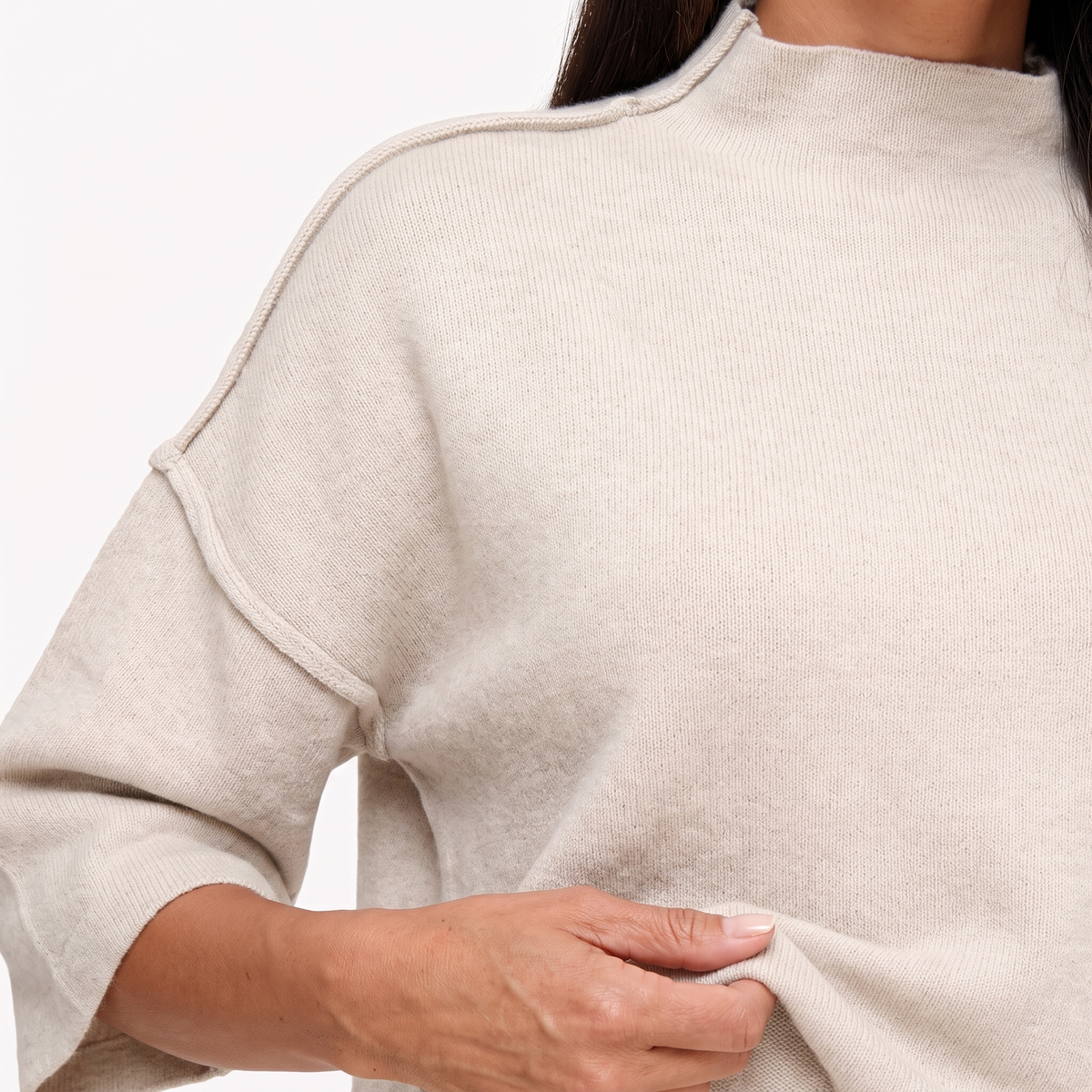 Linnea Taupe close-up of the high neckline, exposed shoulder seam and knit texture.