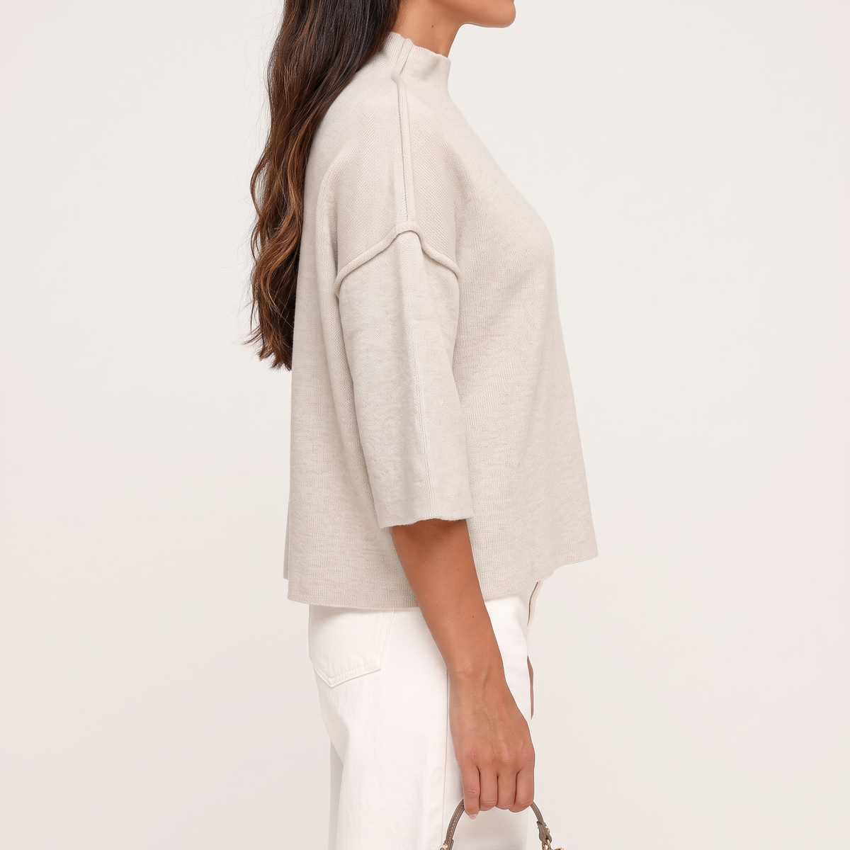 Linnea Taupe high neck knit top shown from the side, highlighting the seam detailing and boxy shape.