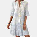 Front view of the Liora Midi Dress Paisley-Print Tiered Tassel-Tie in blue, featuring a split V-neckline with tassel ties, three-quarter sleeves, a paisley print, and a relaxed tiered silhouette. Designed by Bella Hudson.