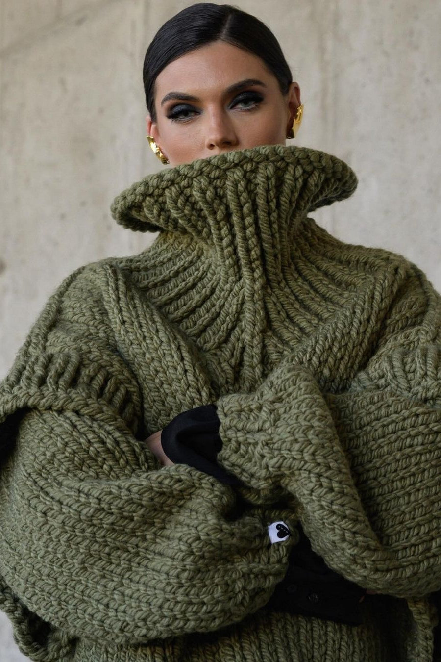 Lydia Green chunky-knit turtleneck sweater close-up of the ribbed turtleneck and thick textured knit.