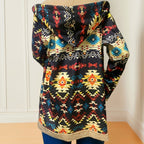 Mabel Beige patterned hooded coat shown worn from the back with an attached hood, bold geometric detailing, and a relaxed everyday fit