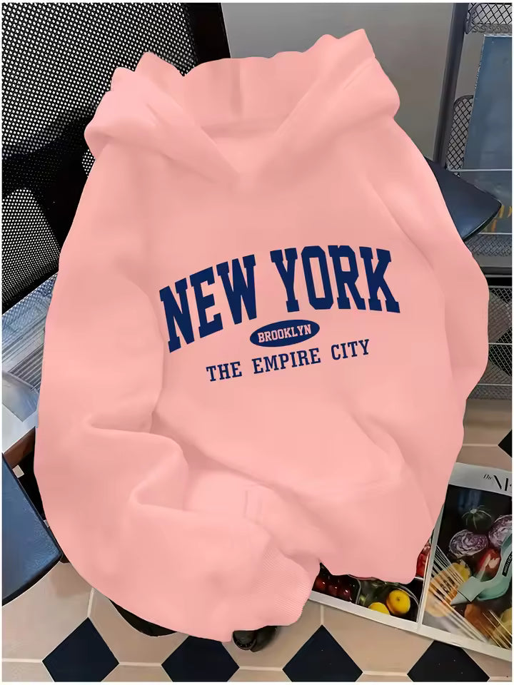 Madison Pink pullover hoodie with New York graphic lettering, long sleeves, relaxed fit, and kangaroo pocket