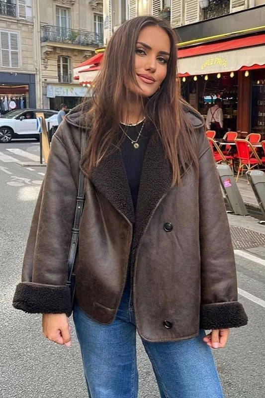 Maeve Brown faux leather jacket featuring a wide lapel collar, plush contrast trim, long sleeves, and button-front closure