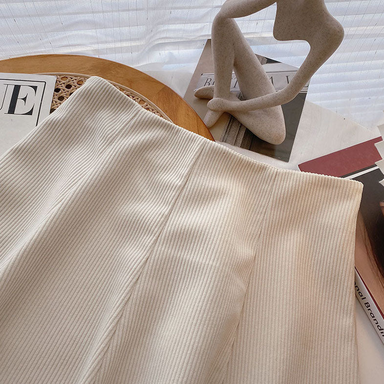 Mara Beige high-waist corduroy mini skirt displayed on a hanger