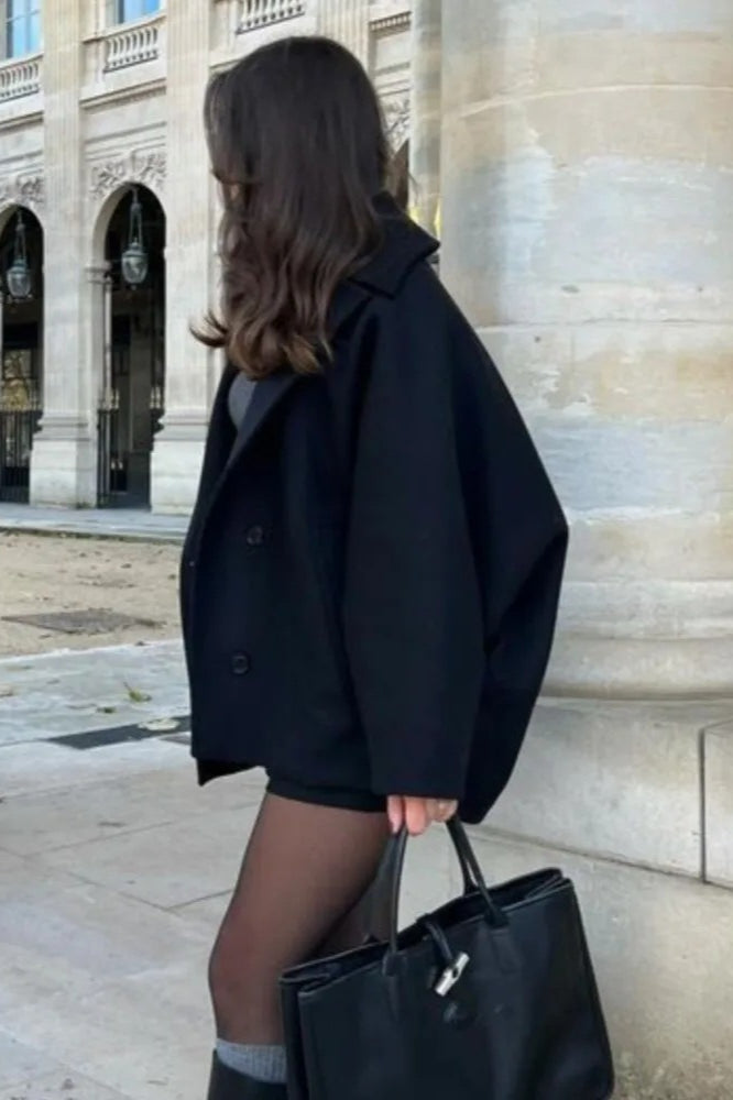 Mara Black short jacket shown from the back and side with a relaxed boxy shape and long sleeves