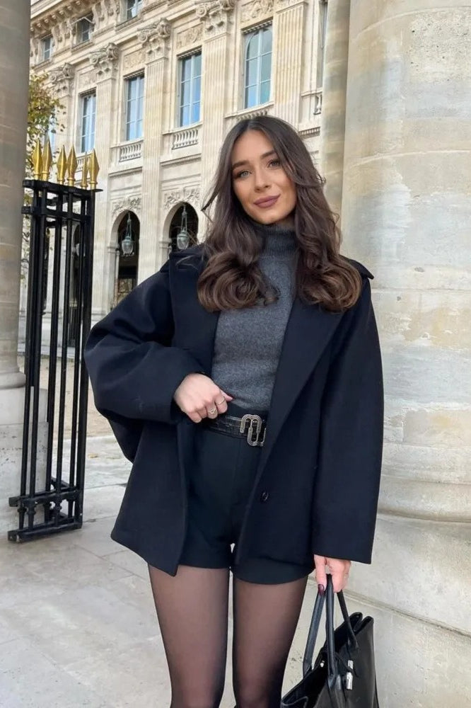 Mara Black double-breasted short jacket shown from the front with structured lapels and a relaxed tailored shape