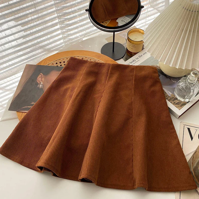Mara Brown high-waist corduroy mini skirt displayed with knitwear and accessories