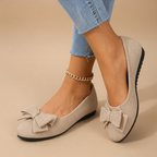 Marceline Ballet Flats Faux Suede Bow-Detail in Beige shown in front view, featuring a soft faux suede upper, elegant bow detail, classic round toe, cushioned insole, and timeless ballet flat silhouette, designed by Bella Hudson.