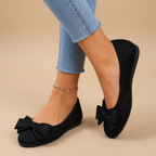 Marceline Ballet Flats Faux Suede Bow-Detail in Black shown in front view, featuring a soft faux suede upper, elegant bow detail, classic round toe, cushioned insole, and timeless ballet flat silhouette, designed by Bella Hudson.