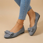 Marceline Ballet Flats Faux Suede Bow-Detail in Grey shown in front view, featuring a soft faux suede upper, elegant bow detail, classic round toe, cushioned insole, and timeless ballet flat silhouette, designed by Bella Hudson.