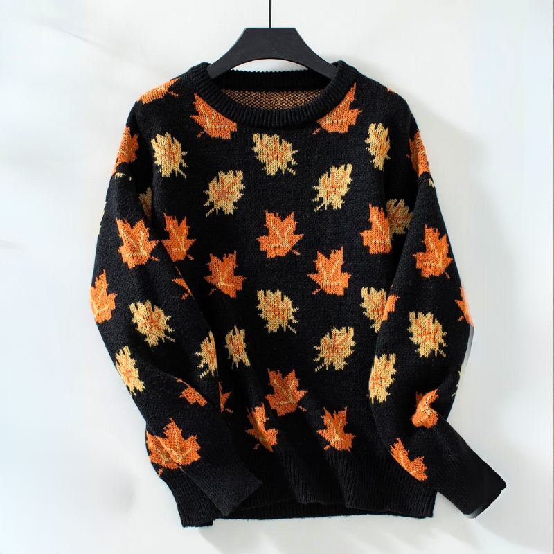 Product view of the Marguerite Sweater Leaf-Print Crew-Neck in black, featuring a crew neckline, long sleeves, orange autumn leaf print, ribbed cuffs and hem, and a relaxed silhouette. Designed by Bella Hudson.