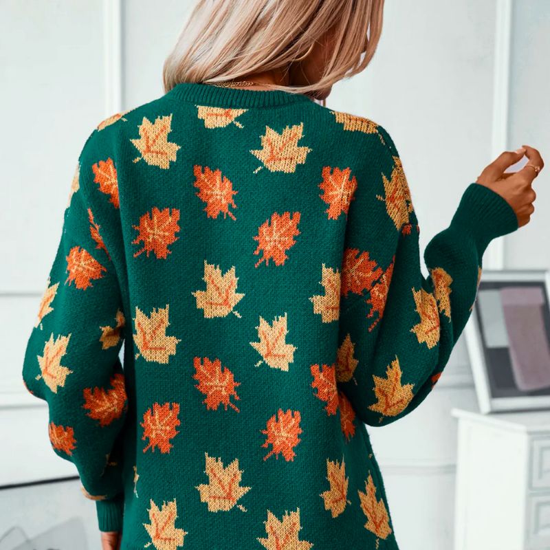 Back view of the Marguerite Sweater Leaf-Print Crew-Neck in green, featuring an all-over orange and yellow autumn leaf print, long sleeves, ribbed cuffs, and a relaxed silhouette. Designed by Bella Hudson.