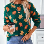 Front lifestyle view of the Marguerite Sweater Leaf-Print Crew-Neck in green, showcasing the crew neckline, long sleeves, orange and yellow autumn leaf print, and relaxed fit. Designed by Bella Hudson.